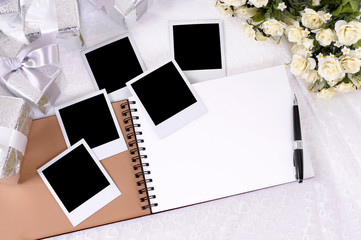 Wedding gifts white lace background with photo album and polaroid style picture frame
