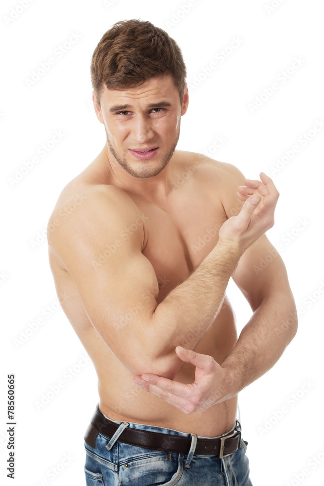 Athletic man feeling pain in his elbow. Athletic man feeling pain in his elbow.