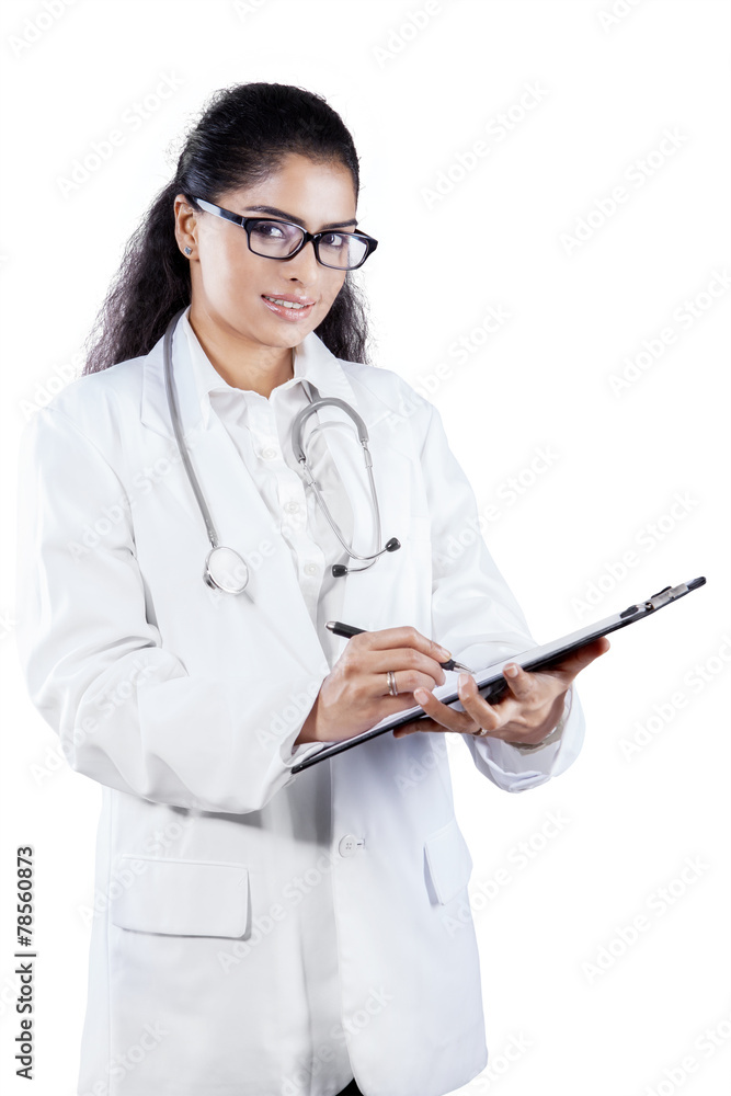 Physician writes prescription on clipboard Physician writes prescription on clipboard
