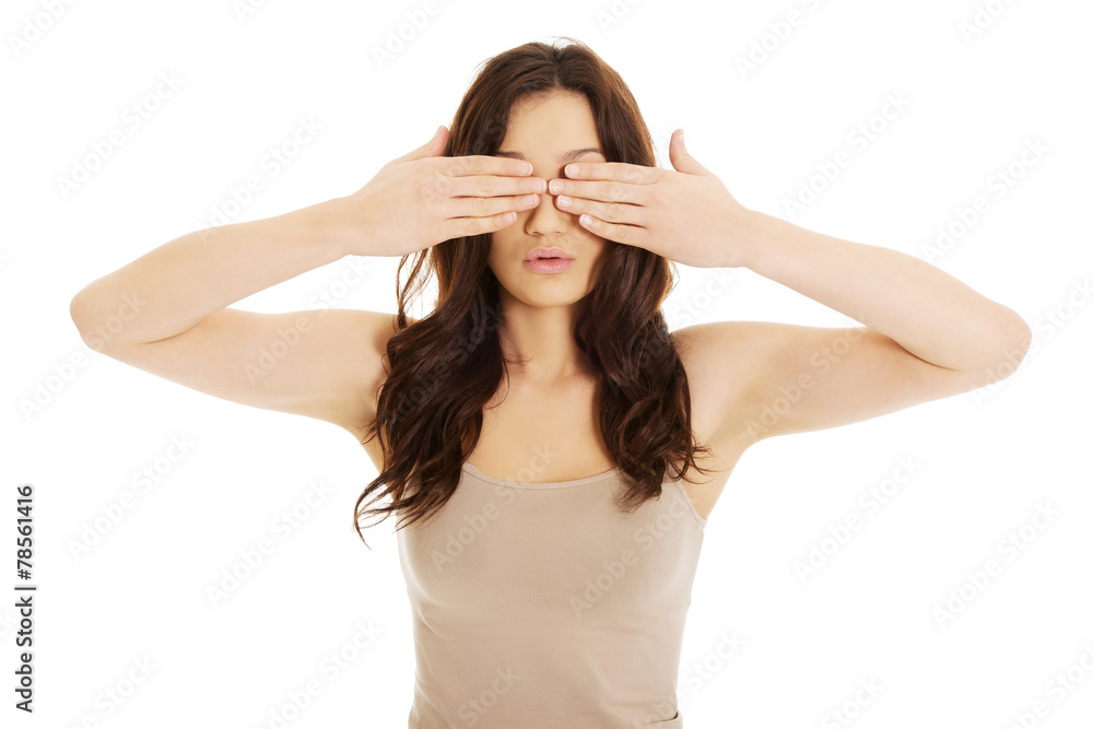 Surprised woman covering her eyes.