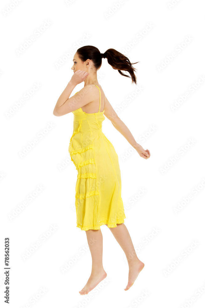Beautiful woman jumping in yellow dress. Beautiful woman jumping in yellow dress.