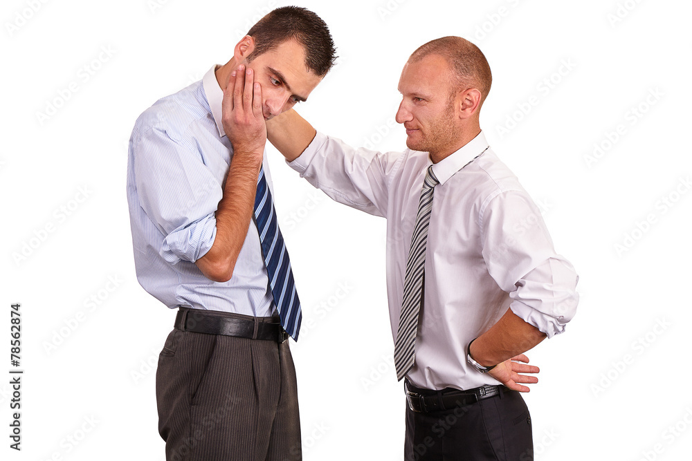 Two businessmen in shirts, troubled, one consoling, comforting a Two businessmen in shirts, troubled, one consoling, comforting a