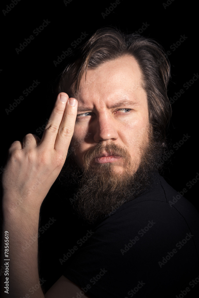 man in black with an imaginary gun playing pantamima man in black with an imaginary gun playing pantamima