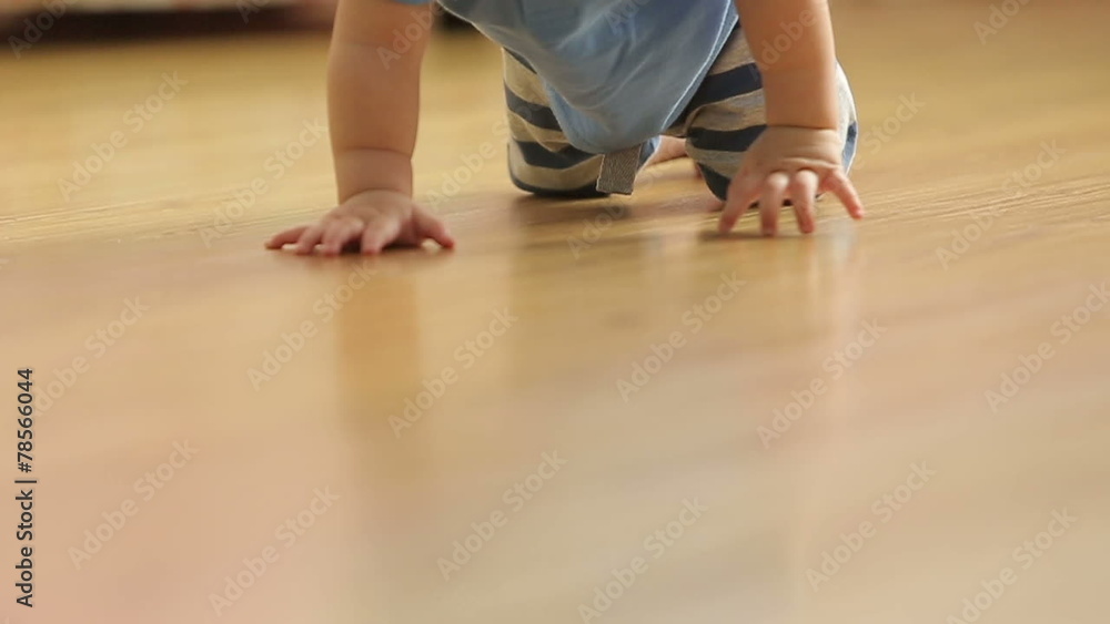 a little funny baby crawling on the floor, back view,slowmotion a little funny baby crawling on the floor, back view,slowmotion