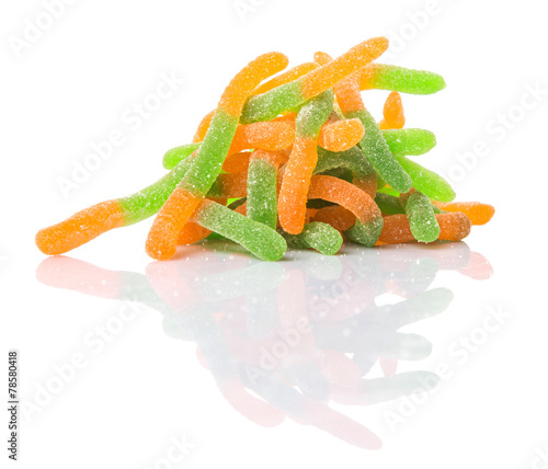 Green and orange sugar jelly candy strip over white background