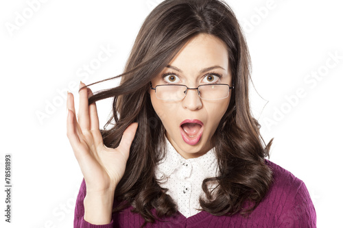 shocked young woman with glasses on a white background