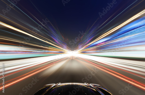 A car driving on a motorway at high speeds,