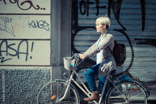 beautiful young blonde short hair hipster woman with bike