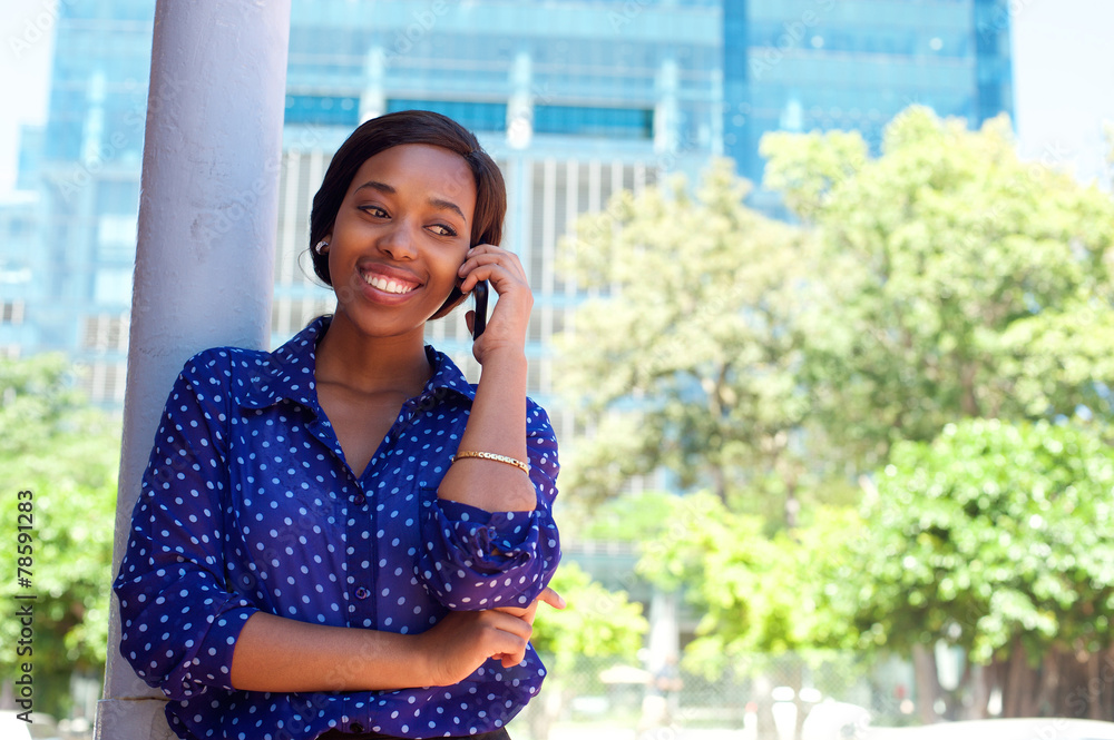 Fototapeta premium Young african american woman smiling with mobile phone