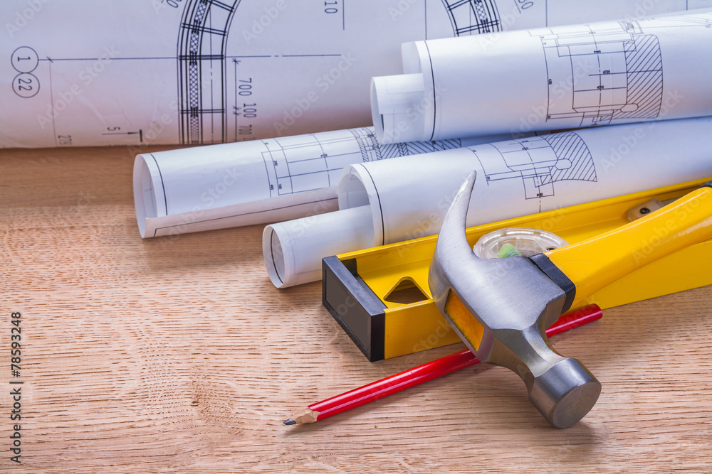 rolled blueprints claw hammer level pencil on wooden boards cons rolled blueprints claw hammer level pencil on wooden boards cons