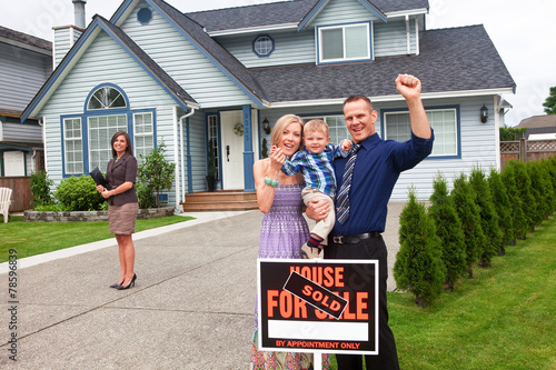 Young family celebrate buying a new home © michaelcourtney