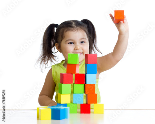 kid plays with building blo...