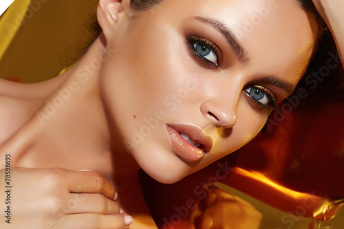 Beautiful sexy woman golden tan evening makeup natural cosmetic