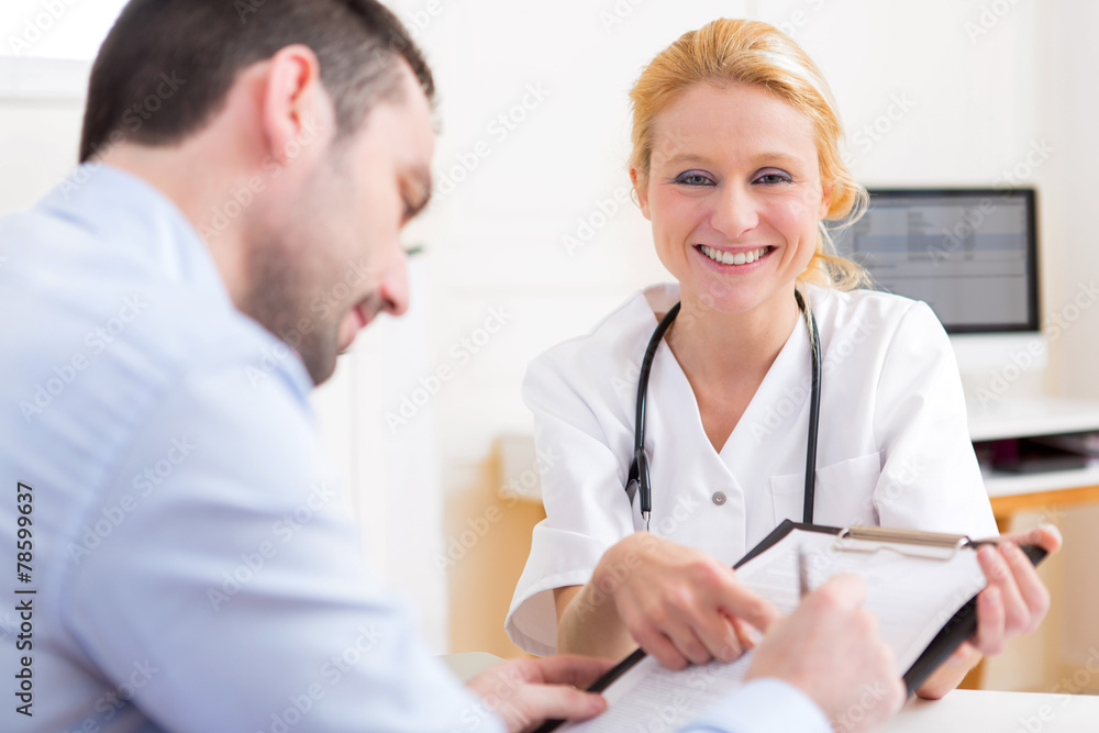 Patient signing the document of a young attractive doctor Patient signing the document of a young attractive doctor