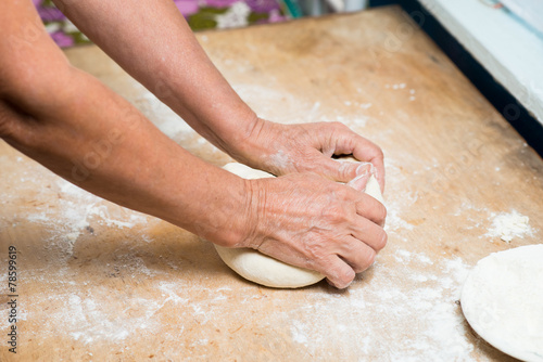 hand with rolling pin and flour