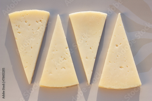 Four slices of semi matured manchego cheese.