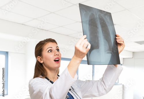 Astonished doctor looking at a radiography photo