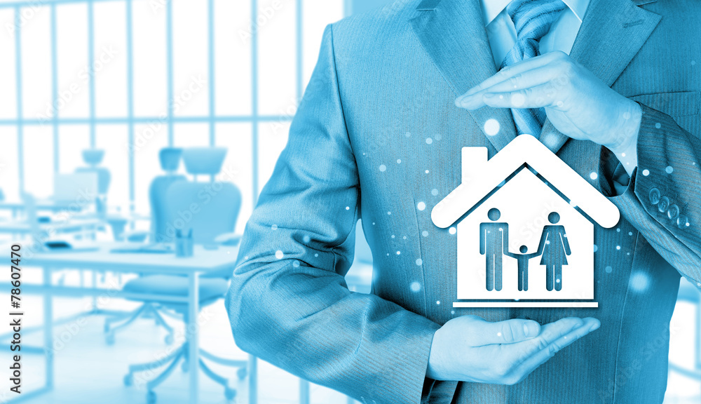 businessman protecting family in home with hands businessman protecting family in home with hands