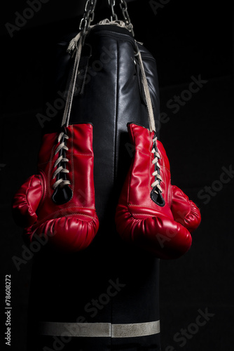 A pair of red boxing glove with low key lighting