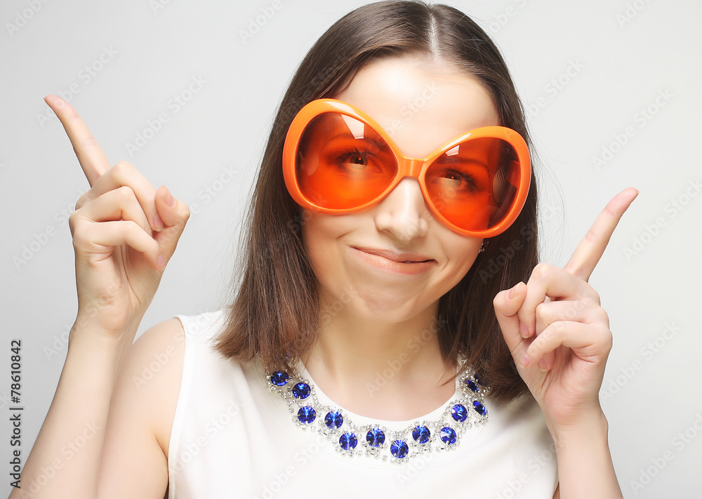 young happy woman with big orange sunglasses young happy woman with big orange sunglasses