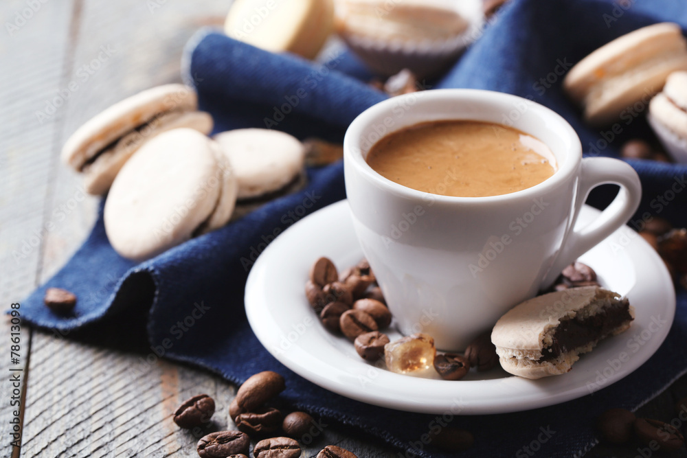 Gentle colorful macaroons and coffee in mug Gentle colorful macaroons and coffee in mug
