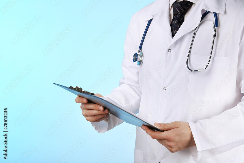 Doctor working with documents on blue background Doctor working with documents on blue background