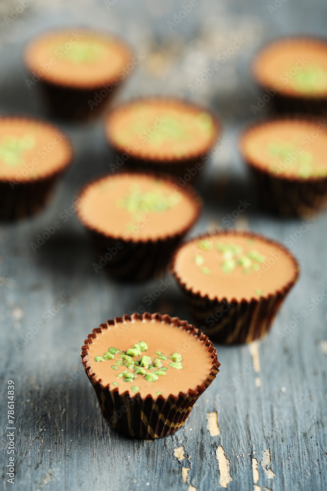Tasty chocolate candies on wooden table Tasty chocolate candies on wooden table