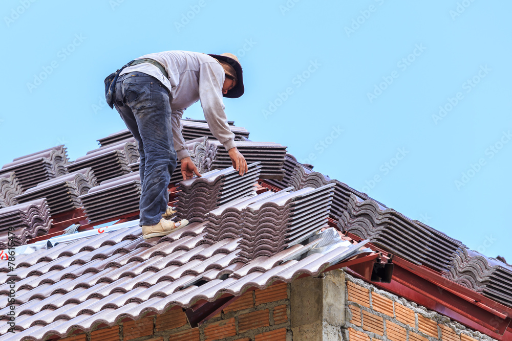 roof under construction with stacks of roof tiles for home build roof under construction with stacks of roof tiles for home build