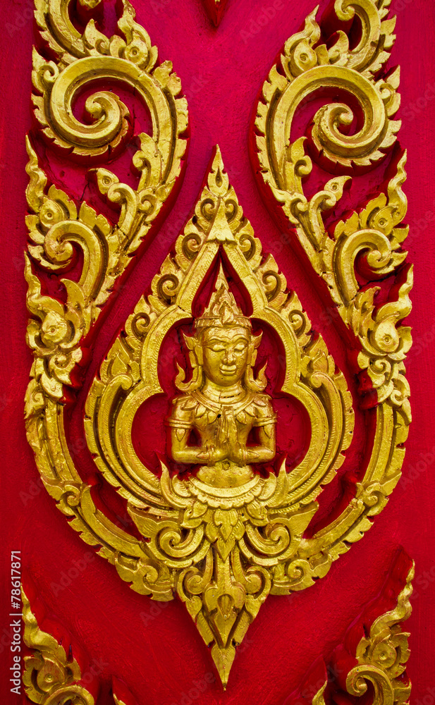 Thai painting carved on a church's door. In the Thai Buddhist te Thai painting carved on a church's door. In the Thai Buddhist te