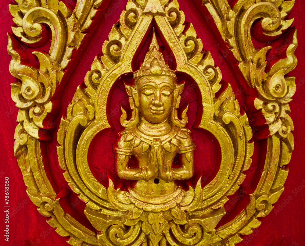 Thai painting carved on a church's door. In the Thai Buddhist te Thai painting carved on a church's door. In the Thai Buddhist te