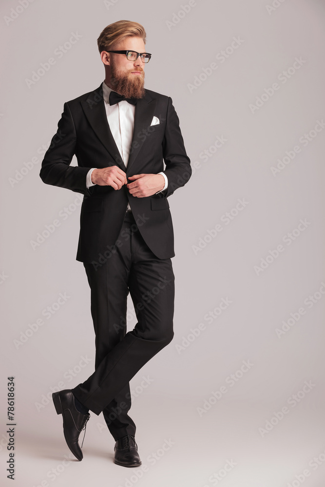 handsome elegant man closing his jacket. handsome elegant man closing his jacket.