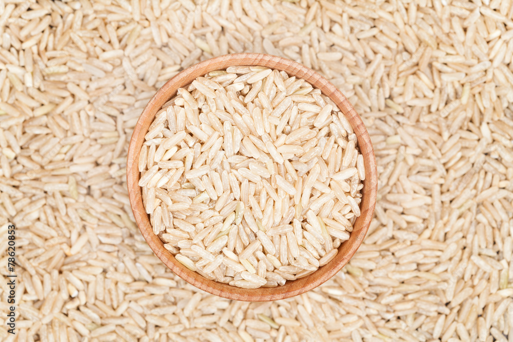 Raw brown rice superfood in a wooden bowl