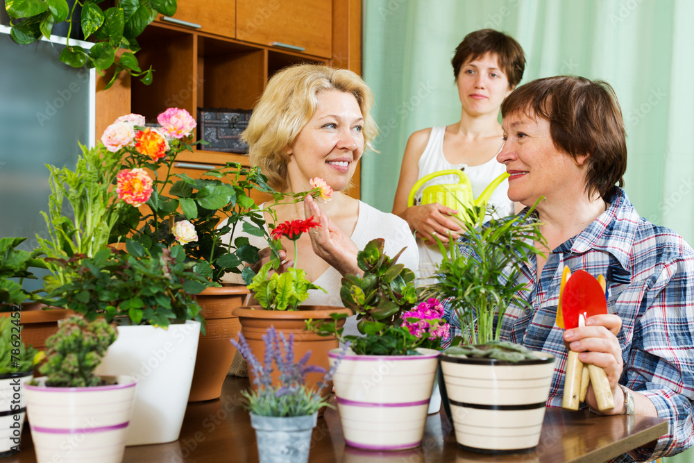 mature women  and girl with many flowerpots