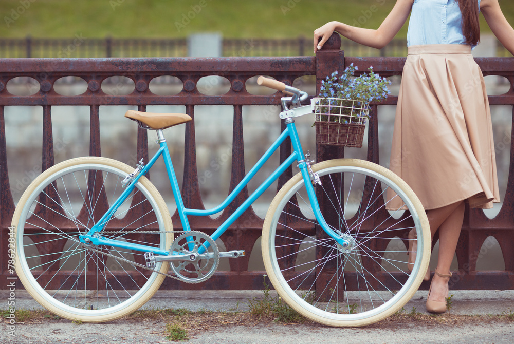 Young beautiful, elegantly dressed woman with bicycle - obrazy, fototapety, plakaty 