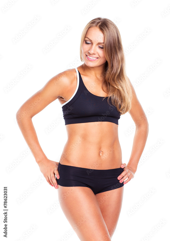 Young sports girl does exercises on a white Young sports girl does exercises on a white