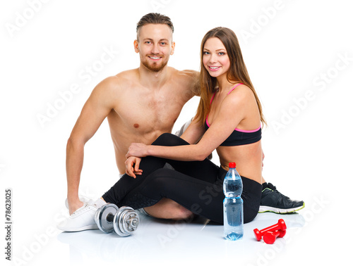 Sport couple - man and woman after fitness exercise with dumbbel