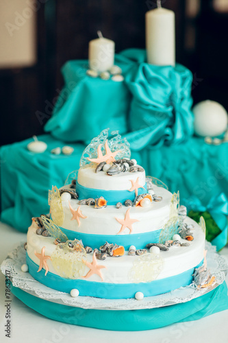 White  wedding cake decorated with seashells