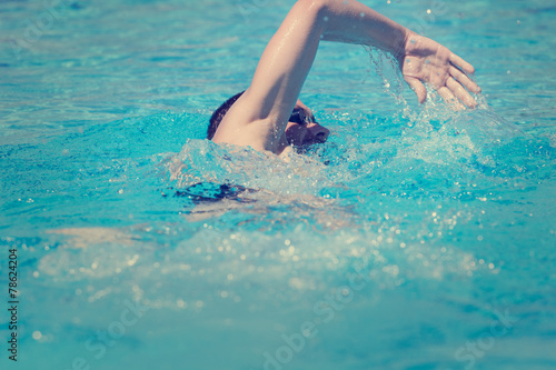 Slim sportsman swimming. © astrosystem