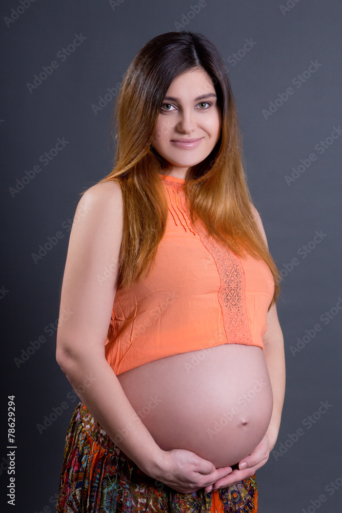 portarit of happy young beautiful pregnant woman posing over gre portarit of happy young beautiful pregnant woman posing over gre