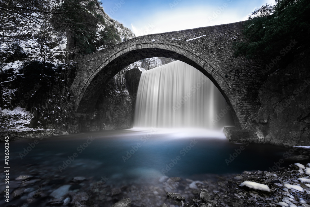 Waterfall under a stone bridge in Palaiokarya, Thessaly, Greece Waterfall under a stone bridge in Palaiokarya, Thessaly, Greece