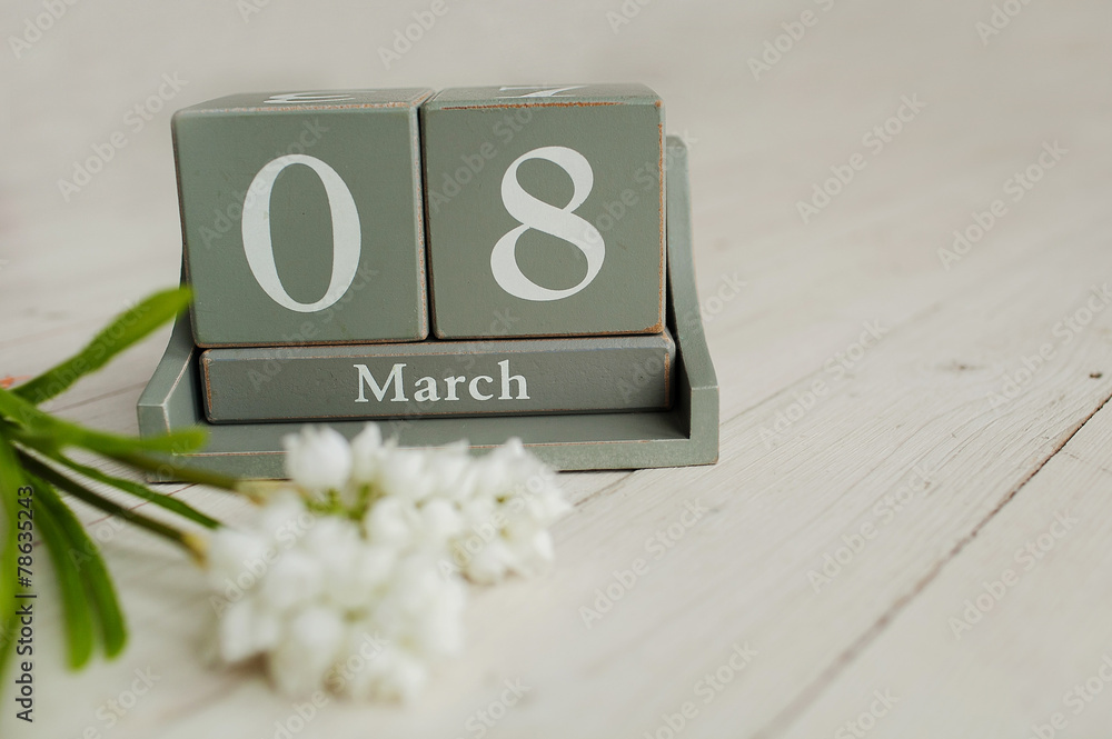 Wooden calendar with 8 March and floowers on white background - obrazy, fototapety, plakaty 