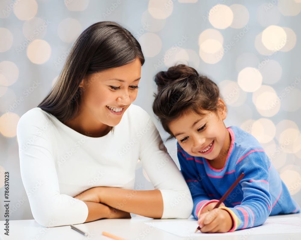 happy mother and daughter drawing with pencils happy mother and daughter drawing with pencils