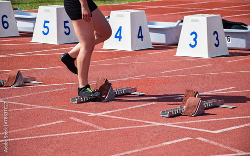 Woman at the starting line of the running track