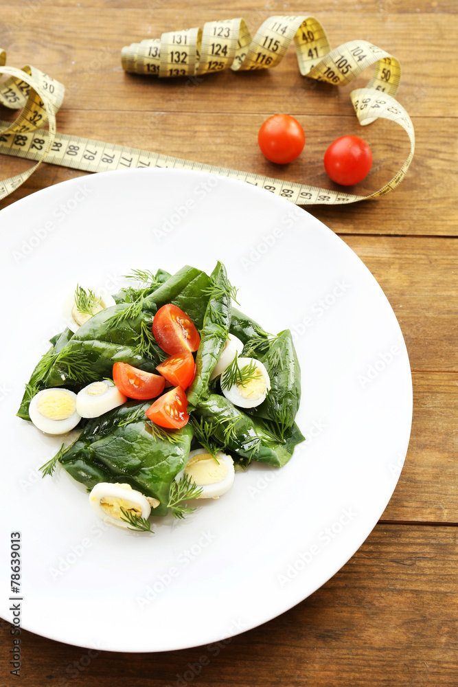 Salad with quail egg and basil in plate