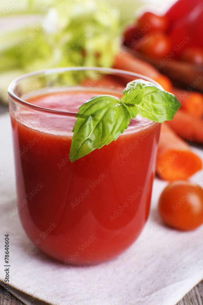 Glass of tomato juice with vegetables on wooden table close up Glass of tomato juice with vegetables on wooden table close up