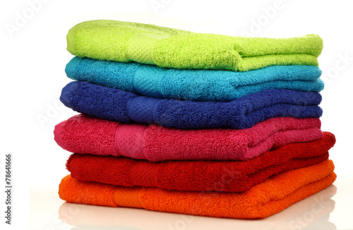 stacked colorful towels on a white background