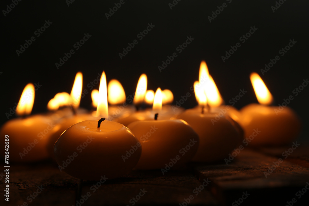 Burning candles close-up on dark background Burning candles close-up on dark background