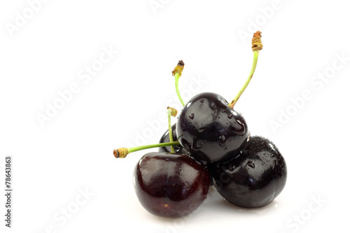  black sweet cherries on a white background