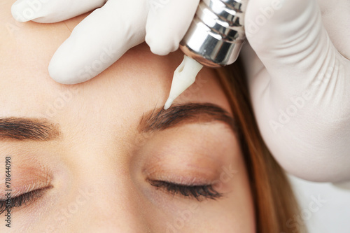 Cosmetologist making perman...