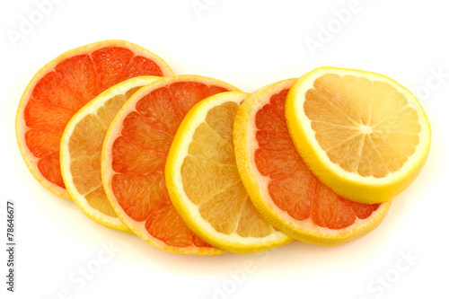 yellow and red grapefruit slices on a white background